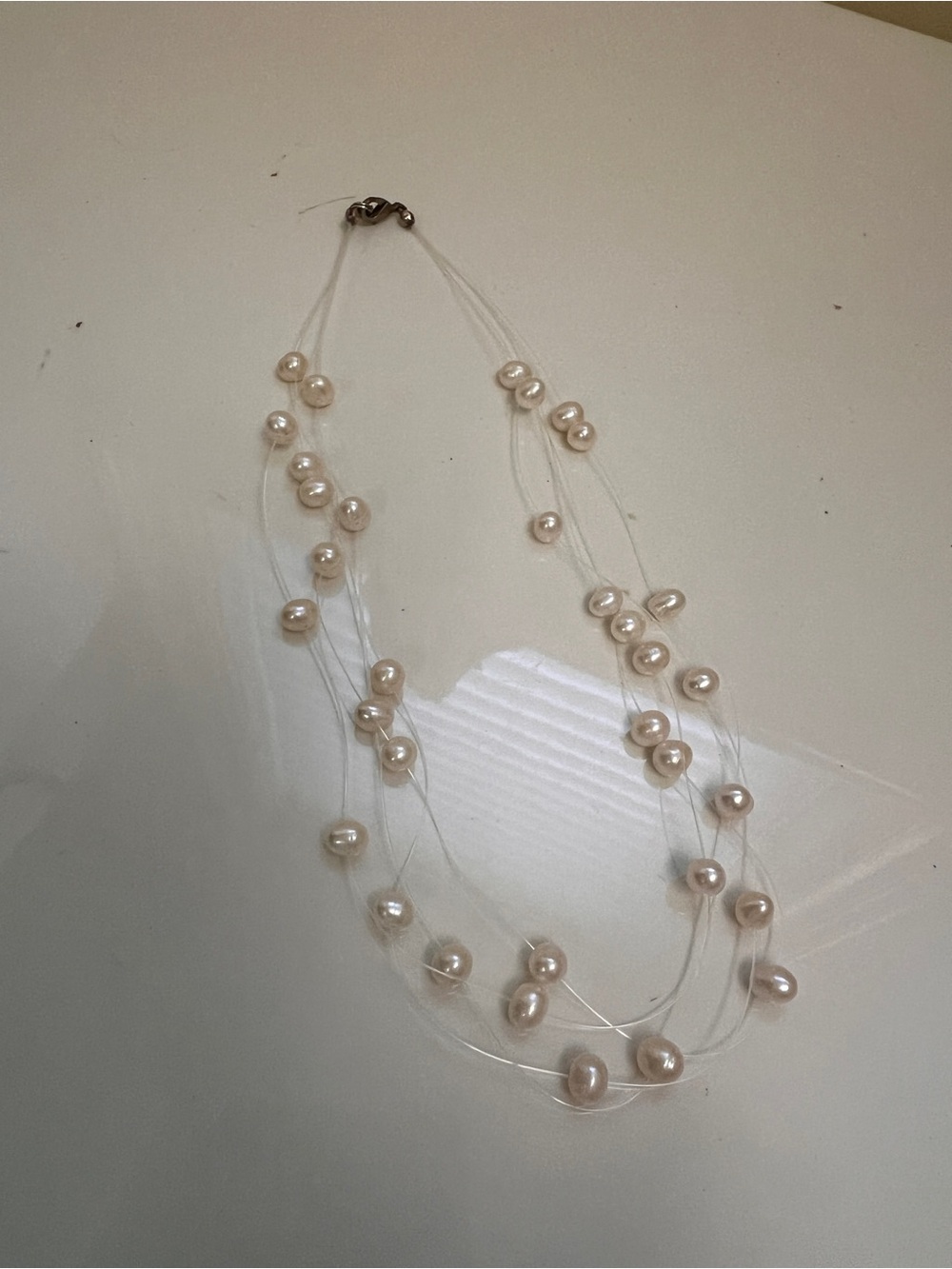 Multi-Strand Cream Pearl Necklace on Clear Cord